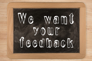Fototapeta premium We want your feedback - chalkboard with outlined text - on wood