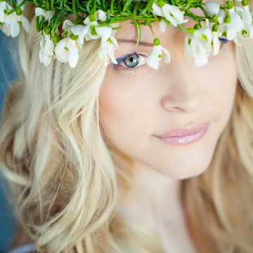 Beautiful woman with snowdrops in her hair 