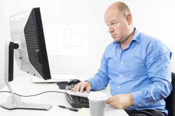 Businessman looking questioning at the computer screen