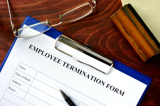Employee termination form on a wooden table.