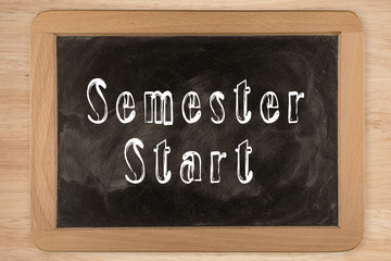 Fototapeta premium Semester Start - chalkboard with outlined text - on wood