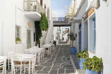 Fototapeta na wymiar Beautiful and graphic stoned alley in Paros island at Greece. 
