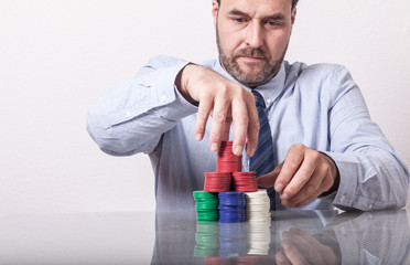 Business man with large stack of poker chips. Mature Caucasian/E