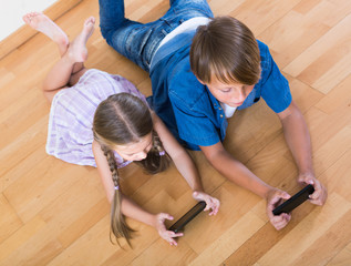 girl and  boy burying in mobile phones