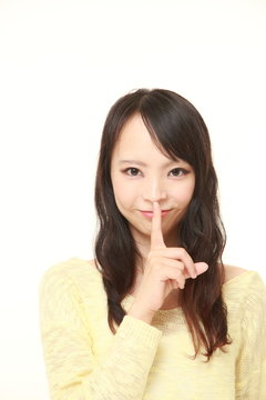 young Japanese woman whith silence gestures 