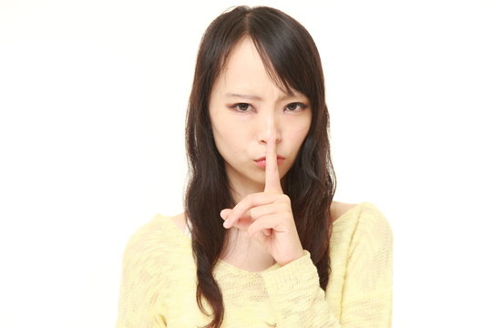 young Japanese woman whith silence gestures 
