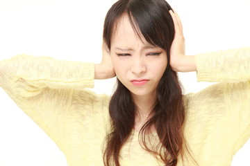 Young Japanese woman suffers from noise