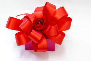 Gift box tied with a red bow.