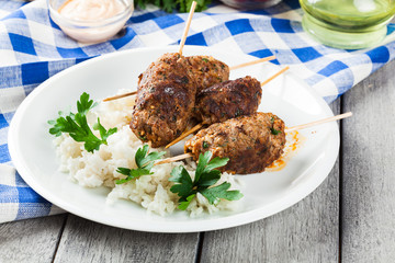 Barbecued kofta with rice on a plate