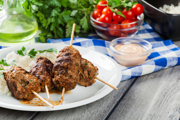 Barbecued kofta with rice on a plate