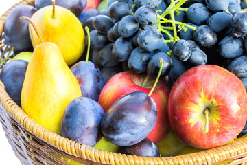 Ripe fruits in a wicker basket close up