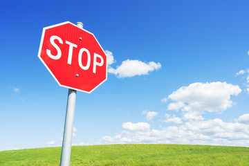 Stop road sign against blue sky