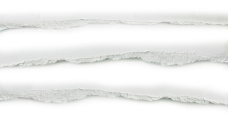 close up of a white ripped piece of paper on white background