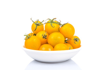 Mini yellow cherry tomato over white background
