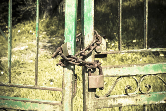 Metal gate closed with padlock