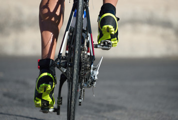 Fototapeta na wymiar Racing- bike detail on gear wheels and feet