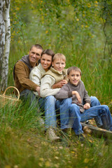 Naklejka na ściany i meble Happy family in autumn forest