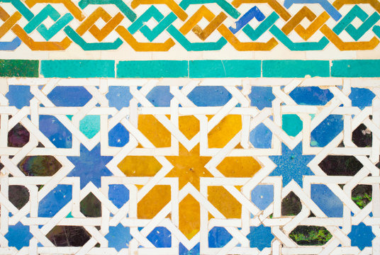 colorful ornate pattern of moorish tile decorations on alhambra