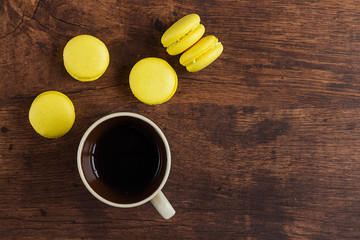 Yellow macarons with coffee