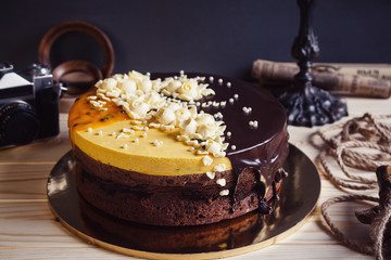 Dark chocolate cake with flowers decorations and mango mousse