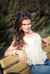 beautiful woman sit on a bench in park