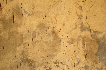 Texture of old wall covered with yellow stucco