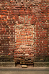 Texture of red brick wall with traces of windows