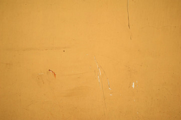 Texture of old wall covered with yellow stucco