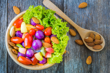 Fresh vegetable salad on wooden background.