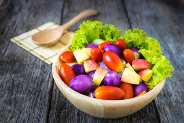 Fresh vegetable salad on wooden background.