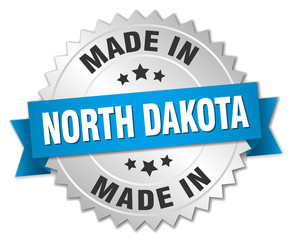 made in North Dakota silver badge with blue ribbon
