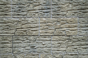 Wall of yellow and gray artificial stone
