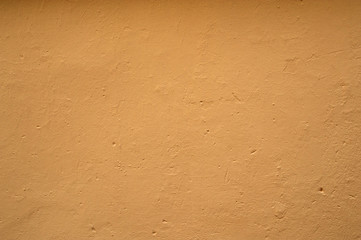 Texture of old wall covered with yellow stucco