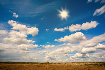 Country landscape in the background of sky with clouds and sun
