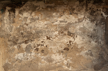 Texture of old wall covered with yellow stucco