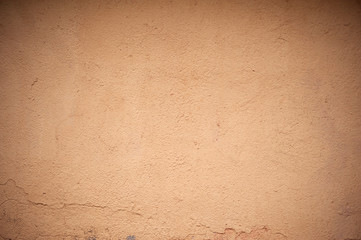 Texture of old wall covered with yellow stucco
