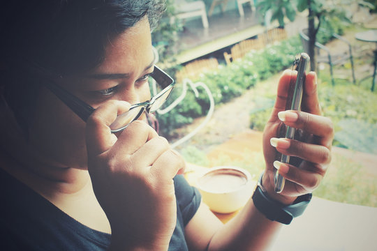 Woman using smartphone with glasses