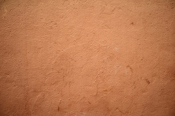 Texture of old wall covered with brown stucco