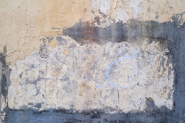 Texture of old wall covered with yellow stucco
