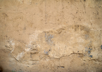 Texture of old wall covered with yellow stucco