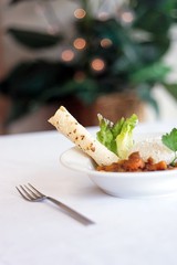 Bowl of Indian vegetable curry with rice and naan