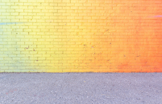 colored brick wall with urban art and graffiti.