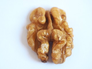 Shelled walnut seed on a white background. 