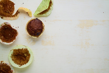Fototapeta na wymiar Freshly baked homemade chocolate muffins on white. Copy space.