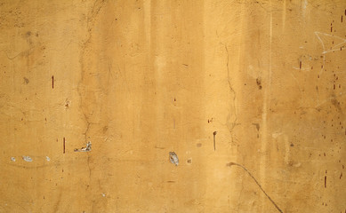 Texture of old wall covered with yellow stucco