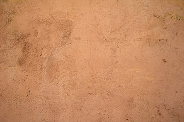 Texture of old wall covered with yellow stucco