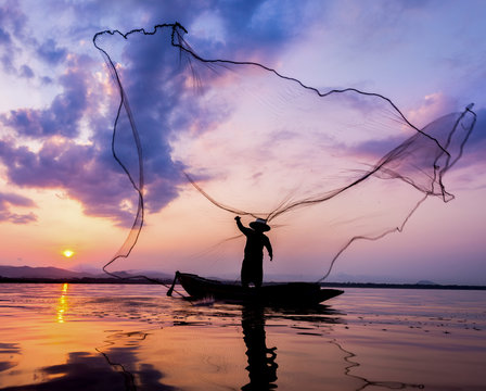Soft focus and  Fisherman of Bangpra Lake in action for fishing Thailand.