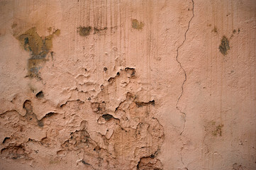 Texture of old wall covered with pink stucco
