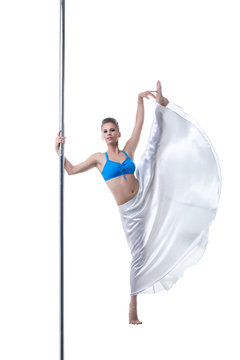 Image of pretty dancer posing in split on pole
