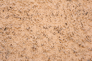 Texture of old wall covered with brown stucco